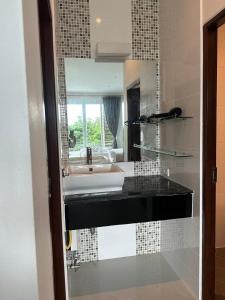 a bathroom with a sink and a mirror at 2 Bedroom Seaview Lanta Sport Resort 303 in Phra Ae beach