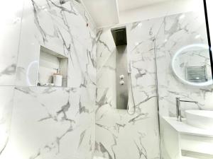 a white bathroom with a shower and a sink at Perugia Family Flat in Perugia