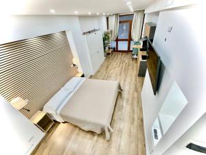a small room with a bed and a staircase at Perugia Family Flat in Perugia