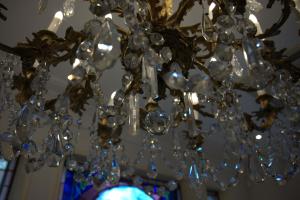 a chandelier with crystals hanging from a ceiling at Hôtel La Villa Eugene in Épernay