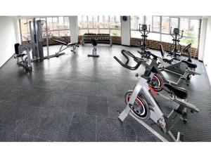 a gym with several treadmills and cardio machines at Apartment Medellinsabaneta near metro station in Sabaneta