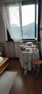 a small table in a room with a window at La Finestra sul Lago in Brusimpiano