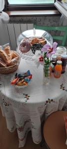 a table with a plate of pastries and flowers on it at La Finestra sul Lago in Brusimpiano