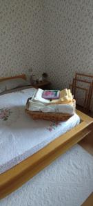 a bed with a wooden frame in a bedroom at La Finestra sul Lago in Brusimpiano