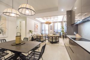 a dining room and living room with a table and chairs at CASONA 6 LUNAS APART Ba-BA1 in Marbella