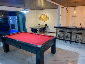 a pool table in a room with a bar at Casa de praia em Penha in Penha