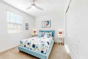 a bedroom with a blue bed and a window at Phoenix Star - Main House & Casita in Phoenix