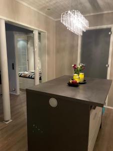 a kitchen with a black island in a room at VuosselinHelmi 44 in Kuusamo