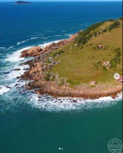 an aerial view of an island in the ocean at Apartamento praia de fora in Palhoça