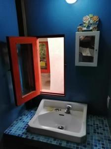 a bathroom with a sink and a mirror at Casa Encantada Guest House in La Aguada