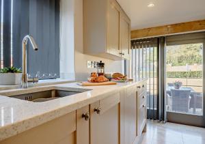 a kitchen with a sink and a counter top at Clerks Cottage in Letheringsett