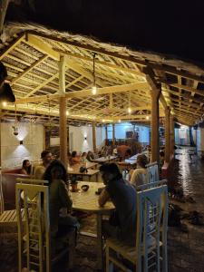 um grupo de pessoas sentadas numa mesa num restaurante em The Lost Hostels, Weligama Beach - Sri Lanka em Weligama