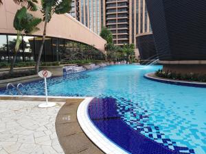 a large swimming pool in the middle of a city at Millennium Suites At Berjaya Times Square KL in Kuala Lumpur
