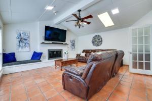 a living room with leather furniture and a flat screen tv at San Antonio Home Private Pool and Covered Patio in San Antonio