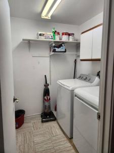 a small laundry room with a washer at Foresight Chalet Laidlaw in Timmins