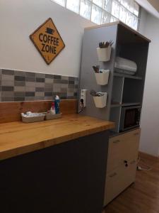 a counter with a coffee zone sign on a wall at Urban rest zone and coworking in Arrecife