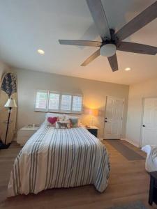 a bedroom with a bed with a ceiling fan at OB Paradise in San Diego
