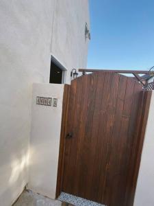 a wooden door in a room with a refrigerator at OB Paradise in San Diego