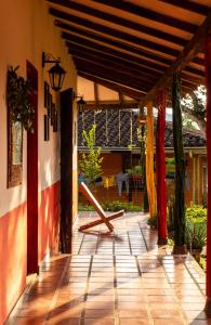 a porch of a house with awning and a table at Casa Finca Genesis in Buga