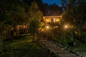 a house with a set of stairs leading up to it at night at MISE CAVE LODGE in Kapchorwa
