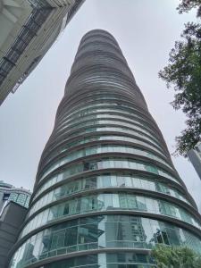 a tall building with a lot of glass windows at Vortex city view klcc in Kuala Lumpur