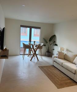 ein Wohnzimmer mit Sofa und Tisch in der Unterkunft Fantástica vivienda situada el el corazón del Puerto de la Cruz in Puerto de la Cruz + 9 Fotos