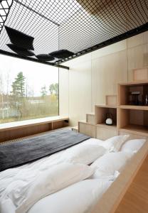 a large bed in a room with a large window at Jägala Juga Nature Resort SPA 