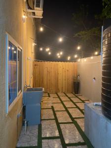 a patio with a toilet and a fence at night at Beautiful 3-Bed House in Saint Catherine Portmore in Central Village