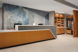 a lobby of a pharmacy with a counter and a pharmacyacist at SpringHill Suites By Marriott Charleston Airport & Convention Center in Charleston
