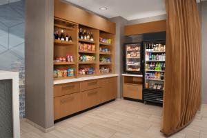 a room with a refrigerator and shelves with alcohol at SpringHill Suites By Marriott Charleston Airport & Convention Center in Charleston