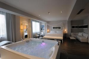 a hotel room with a bath tub with a bed at Park Hotel Sporting in Teramo +37 photos
