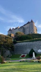 a castle sitting on top of a stone wall at Duchesse de Berry - Vue sur port in Dieppe