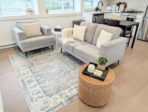 a living room with a couch and two chairs and a table at Centrally located, modern, 2 bedroom home in Vancouver