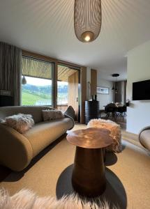 a living room with a couch and a table at the NEST flims in Flims