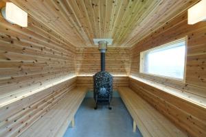a sauna with a stove in the middle at Private sauna stay Shinori - Vacation STAY 34530v in Hakodate