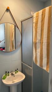 a bathroom with a sink and a mirror at Pousada Sol & Mar in Guaratuba