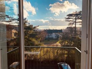 a window of a balcony with a view of a city at Cocon berrichon Châteauroux-Déols in Déols