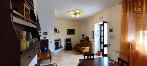 a living room with a couch and a table at casa vacanze “Tra cielo e mare” Agerola in Agerola