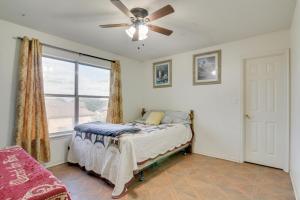 a bedroom with a bed with a ceiling fan and a window at McAllen Vacation Rental Less Than 10 Mi to La Plaza Mall! in McAllen