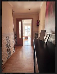 a kitchen with a black counter top and a hallway at Vista a la montaña Briviesca in Briviesca