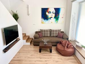 a living room with a couch and a tv at Apartment Brno- BBQ terrace in Husovice