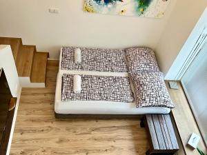 two beds sitting on a wooden floor in a room at Apartment Brno- BBQ terrace in Husovice