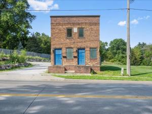 a brick house with blue doors on a street at Chic 2br - 2 Min From Icubs in Des Moines
