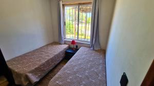 Voodi või voodid majutusasutuse Complejo Cabañas Piriápolis toas