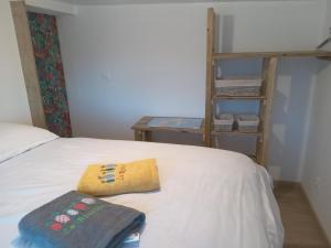 a bedroom with a bed with two pillows on it at Le Jardin in Saint-Leu