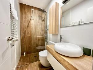 a bathroom with a white sink and a toilet at Apartamentos Chamberí in Madrid