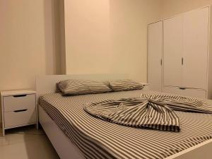 a bedroom with two beds and a white cabinet at ArtLife apartments (grafic arts) in Alanya +28 photos