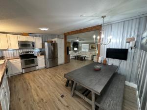 a kitchen and living room with a wooden table at Waterfront Canal in Satsuma Florida in Satsuma
