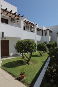 a white building with trees in front of it at George SkyrosStudios in Skiros
