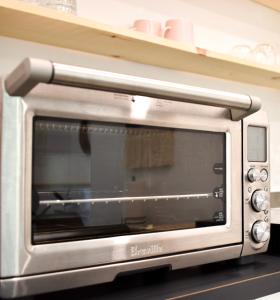 a silver toaster oven sitting on a shelf at Salal Suite Ukee in Ucluelet